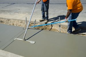 Workers laying concrete for a foundation in Conroe