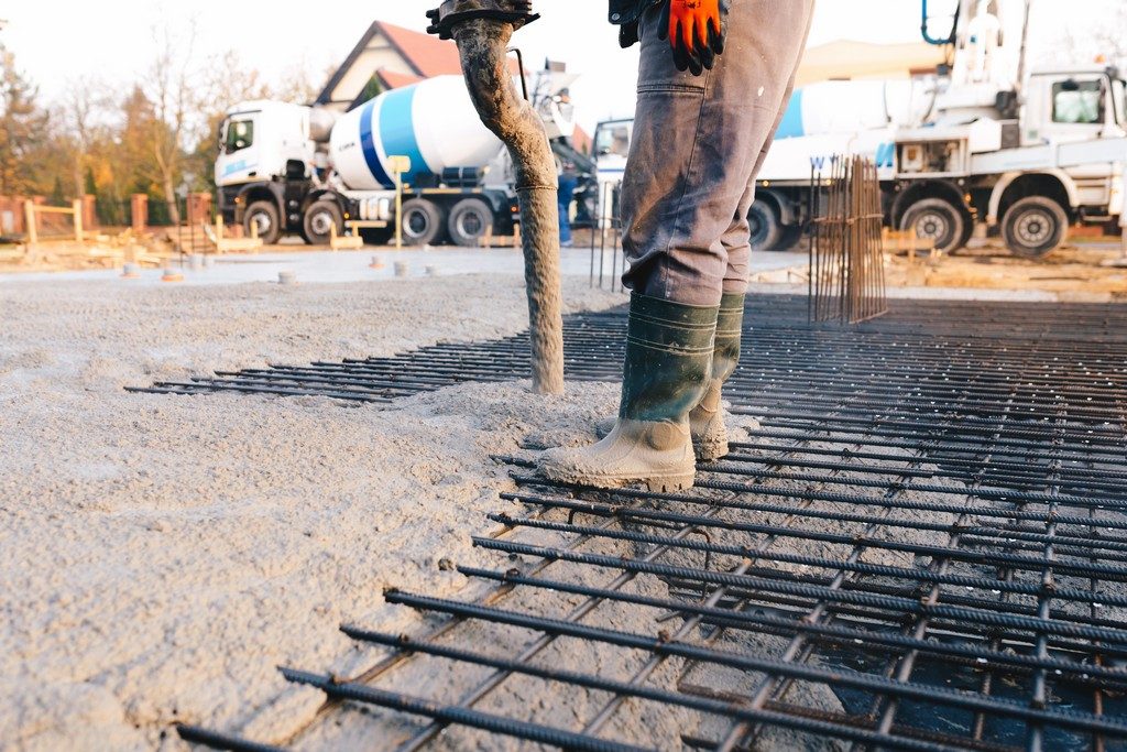 Concrete worker laying a foundation for a business in Conroe